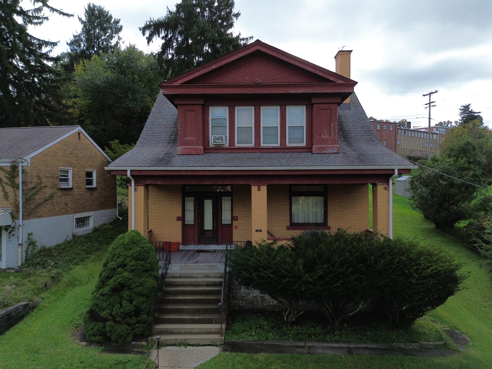 Before: the house front under a flat grey sky