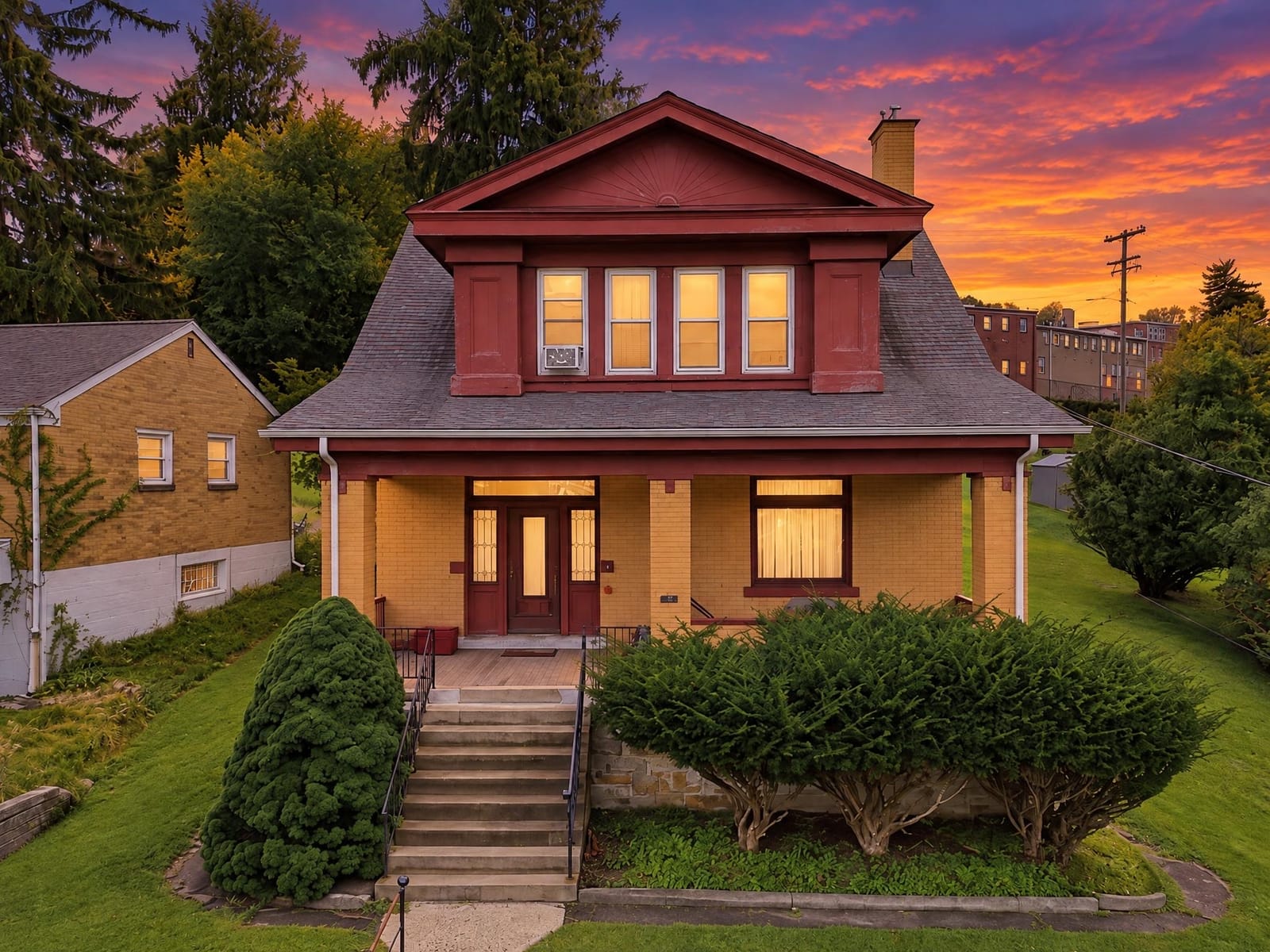 Twilight: the same house at dusk with warm lit windows